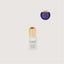 Skincare serum bottle with gold cap on a light gray background, featuring an award badge.
