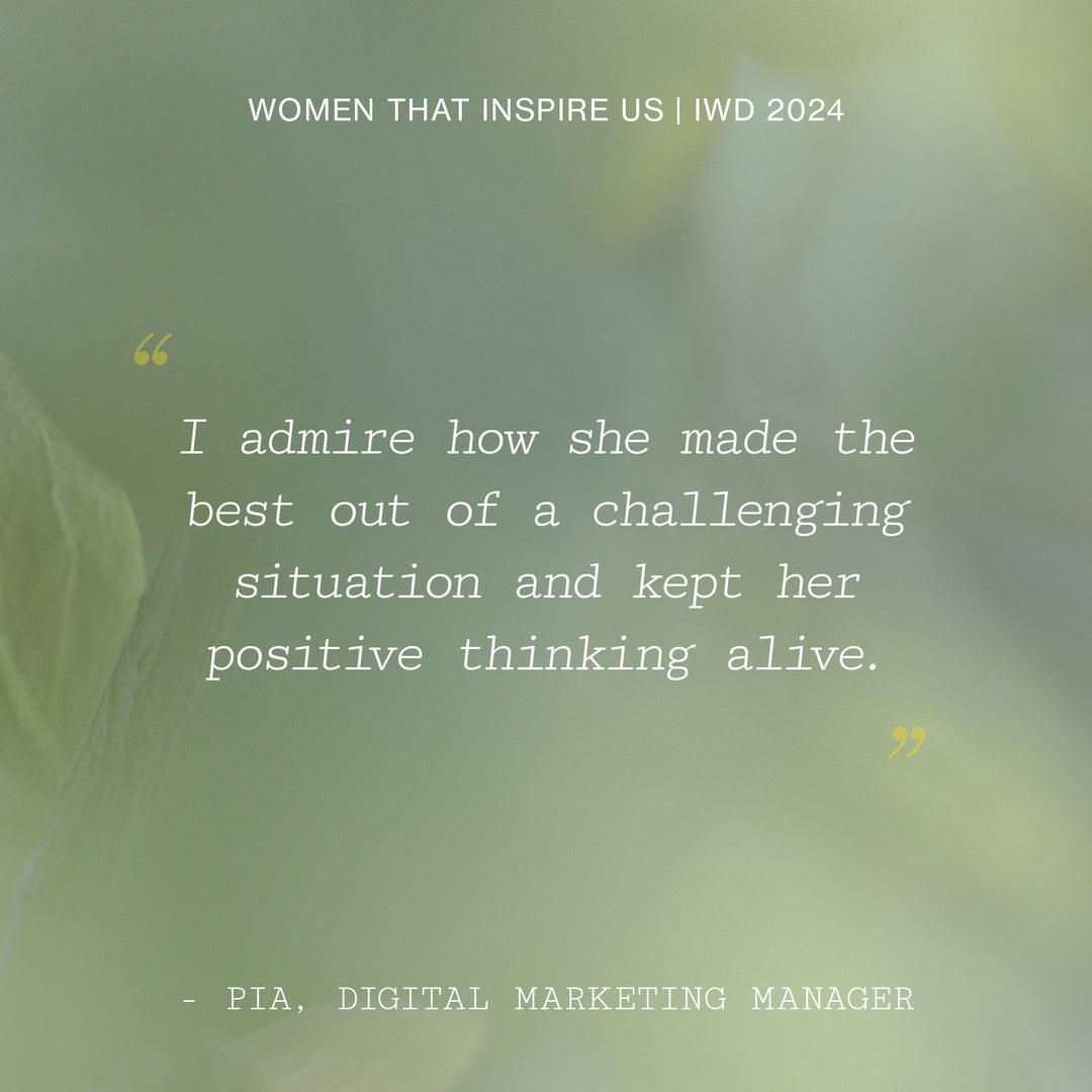 Inspirational IWD 2024 quote on a blurry green background, praising a woman's positivity in adversity.